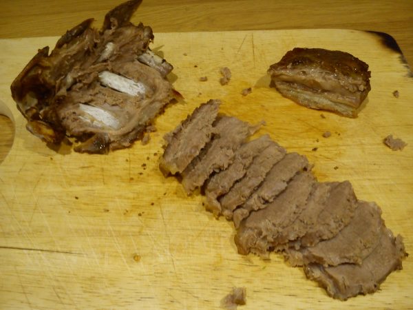 The loin separated from the bone with the fillet piece at top right-hand corner.