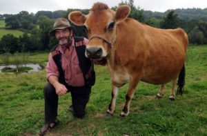 Simon Fairlie, author of 'Meat - a benign extravagance', with a Jersey cow at the Monkton Wyld Court Sustainable Living Commune near Charmouth. Picture: Murray Sanders.